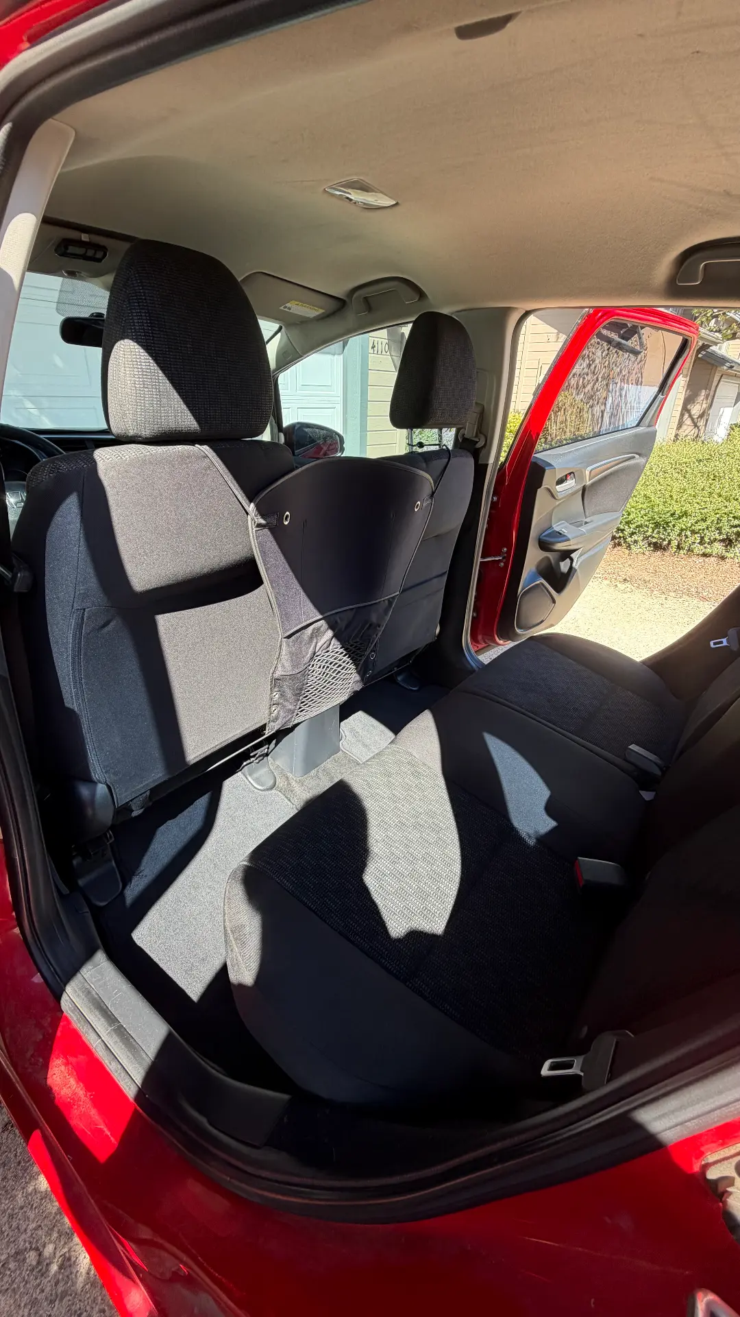 Red Honda Fit rear seats after detail