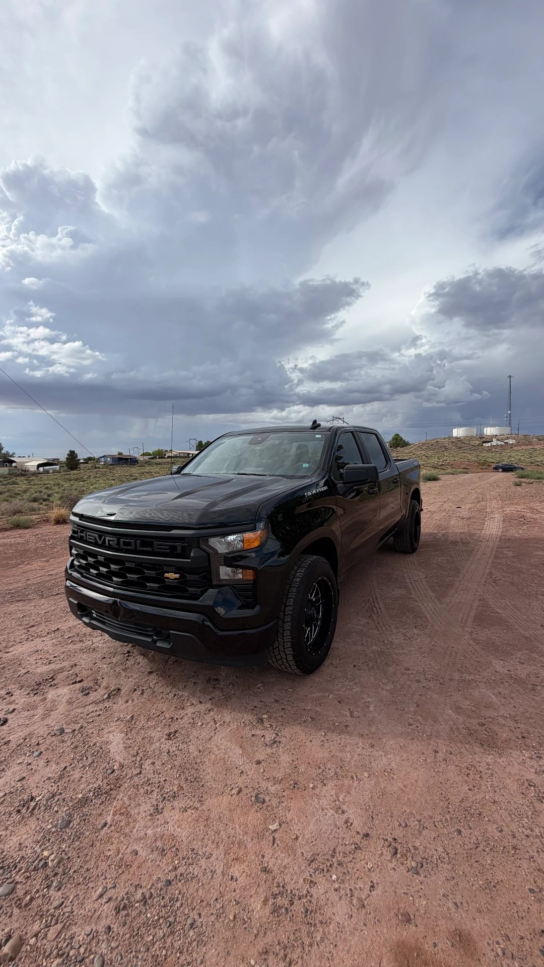 Black Chevrolet Silverado under stormy sky